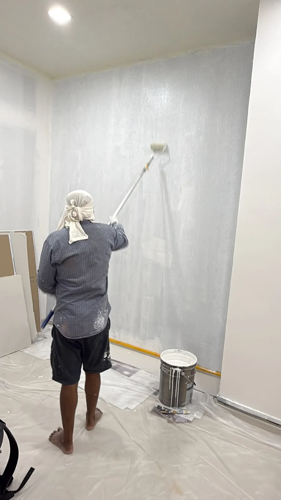 Hallway corridor painted in clean neutral tone with protected floor edges